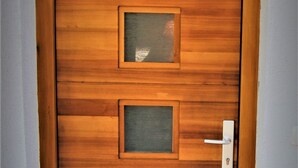 A wooden door with three glass panels and a keyhole. - Rose Valley Ljubljana (Ljubljana)
