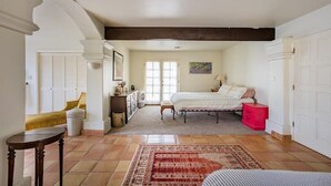 Un dormitorio con cama, mesita de noche, cómoda y ventana.