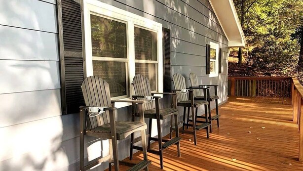 A deck with wooden flooring and Adirondack chairs. - Maes Cottage In The Clouds (Blue Ridge)