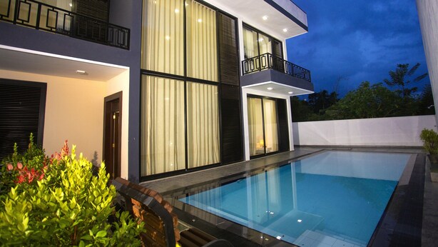 A modern two-story house with a swimming pool, large windows, and a balcony. - Luxury Villa with privet outdoor swiming pool. (Kundasale)