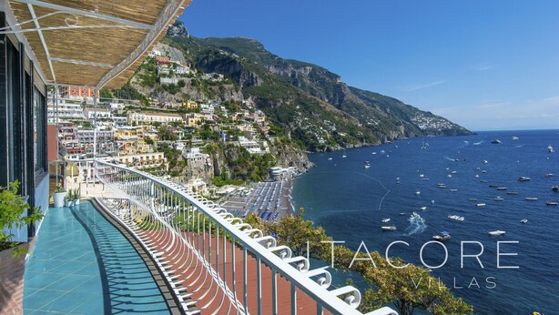 A balcony with a view of a coastal town, a clear blue sky, and the sea with boats. - Casa Stella Marisa Positano - Unique Sea View Terrace near Beach & Center (Positano)