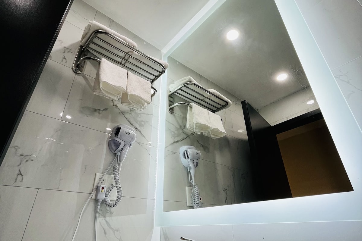 rainfall showerhead, hair dryer, towels, soap