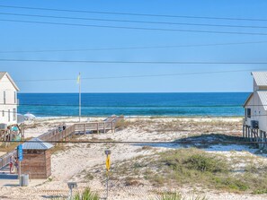 A beachside property with a wooden deck, beach access sign, and a view of the ocean. - Sea Urchins, Unit 1 5 BR. Beachview. The Beach, so close, for less! Pool. (Gulf Shores)