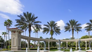 A fountain with dolphins, palm trees, and a sign reading "Emerald Island". - Palm Key Villa by VillaDirect (Kissimmee)