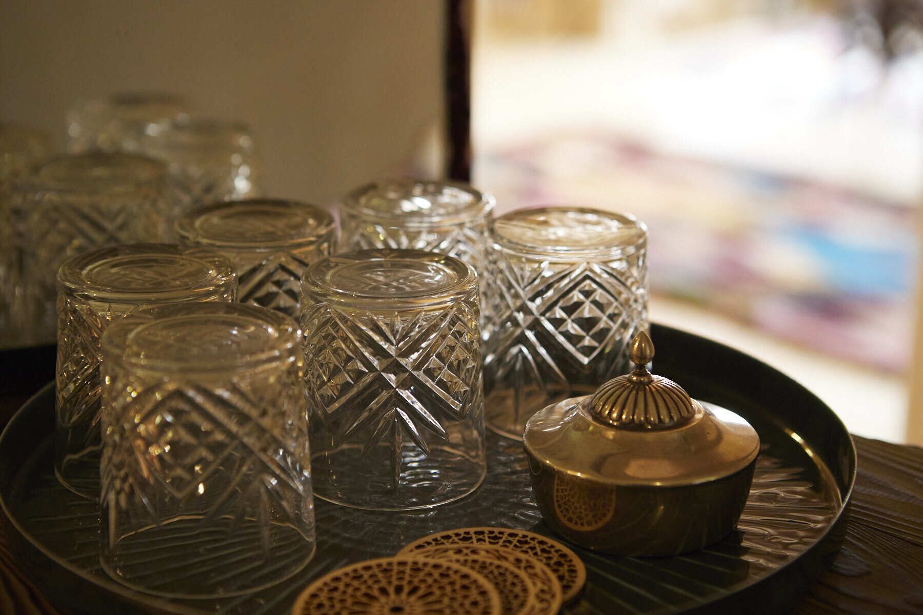 A tray with several glass containers and a metal lid, likely for serving or storing food.