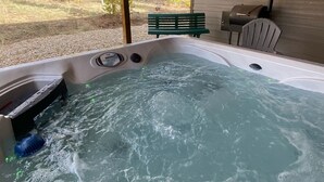 A hot tub with a wooden ceiling and a view of a backyard with a bench and a grill. - Mountain Meadow, 3-bedroom vacation home, close to RMNP & lakes, Hot tub, W/D (Grand Lake)