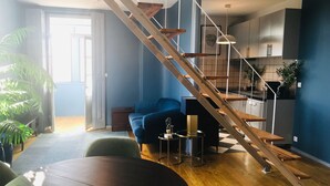 A modern living space with a wooden staircase, a dining area, and a kitchen. - ★ Romantic - Casa Bela ★ Penthouse with views (Porto)
