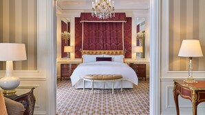 A luxurious hotel bedroom with a large bed, ornate chandelier, and classic decor. - 5th & 55th Residence Club (New York)