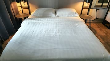 Desk, iron/ironing board, bed sheets