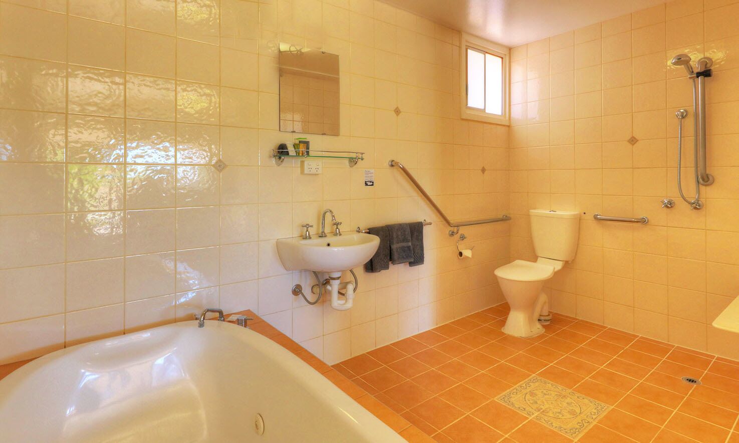 A bathroom with a bathtub, sink, toilet, and shower.