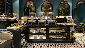 A buffet setup with various food items and dishes. - Grande Collection Hotel & Spa (Hanoi)