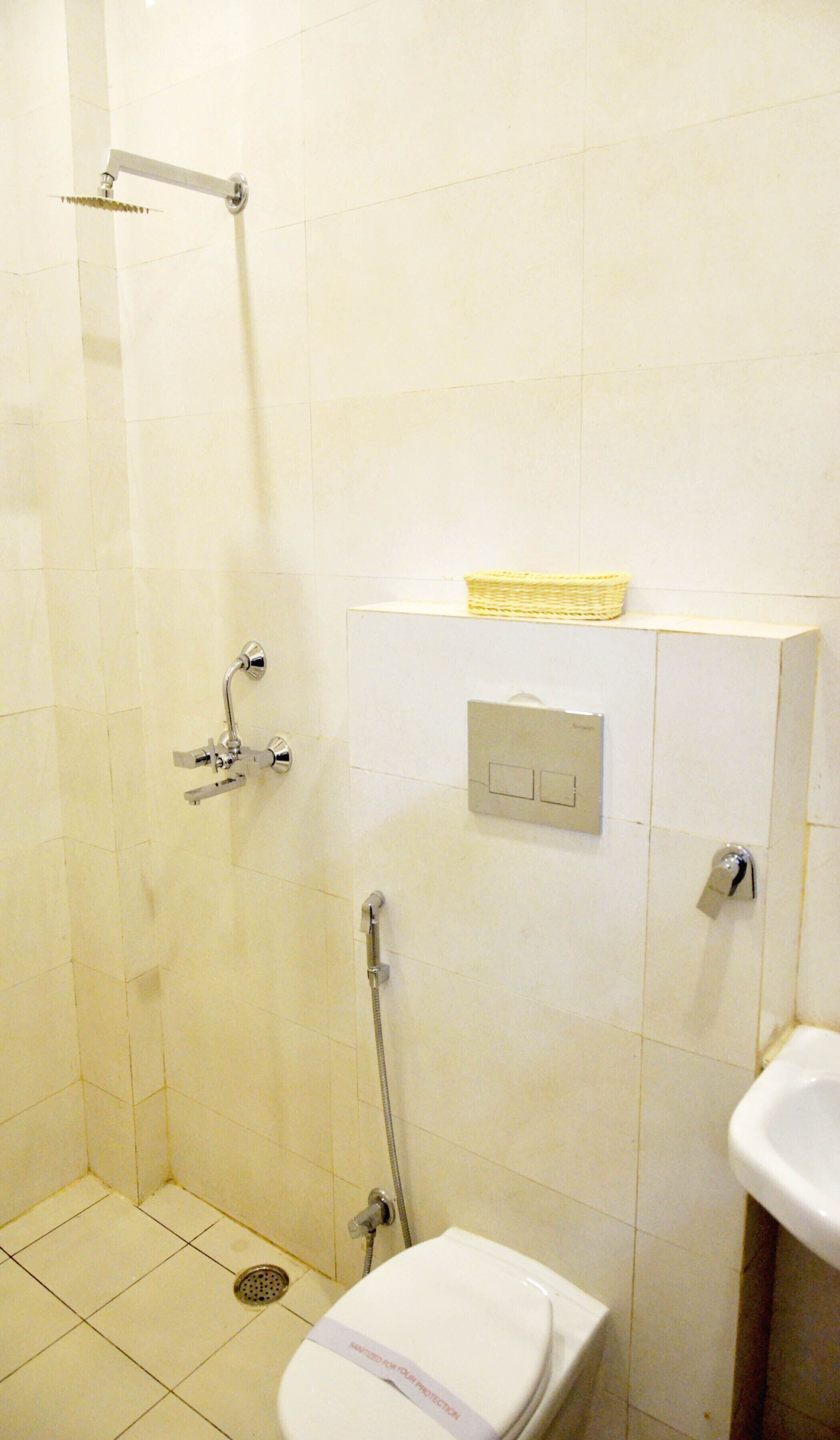 A bathroom with a shower, toilet, and sink.