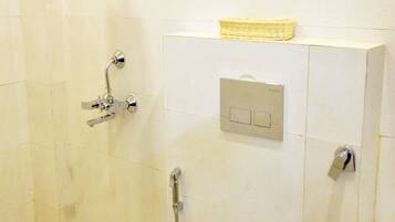 A bathroom with a shower, toilet, and sink.