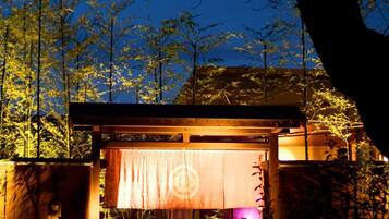 A traditional Japanese building with a wooden structure and a covered entrance.