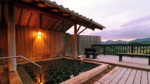 A wooden spa with a hot spring, wooden deck, and a view of mountains. - Kafutei (Yamaga)