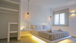 A modern bedroom with a built-in bed, bedside tables, and ambient lighting. - Nida Mykonos (Mykonos)