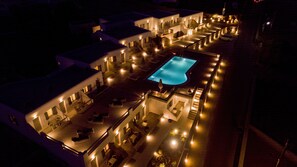 An aerial view of a hotel with a central swimming pool, multiple connected buildings, and outdoor seating areas. - Nida Mykonos (Mykonos)