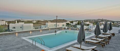 Seasonal outdoor pool, open 9:00 AM to 9:00 PM, pool umbrellas