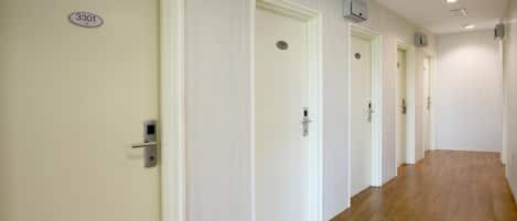 A hallway with doors numbered 3301, 3302, and 3303, leading to rooms.