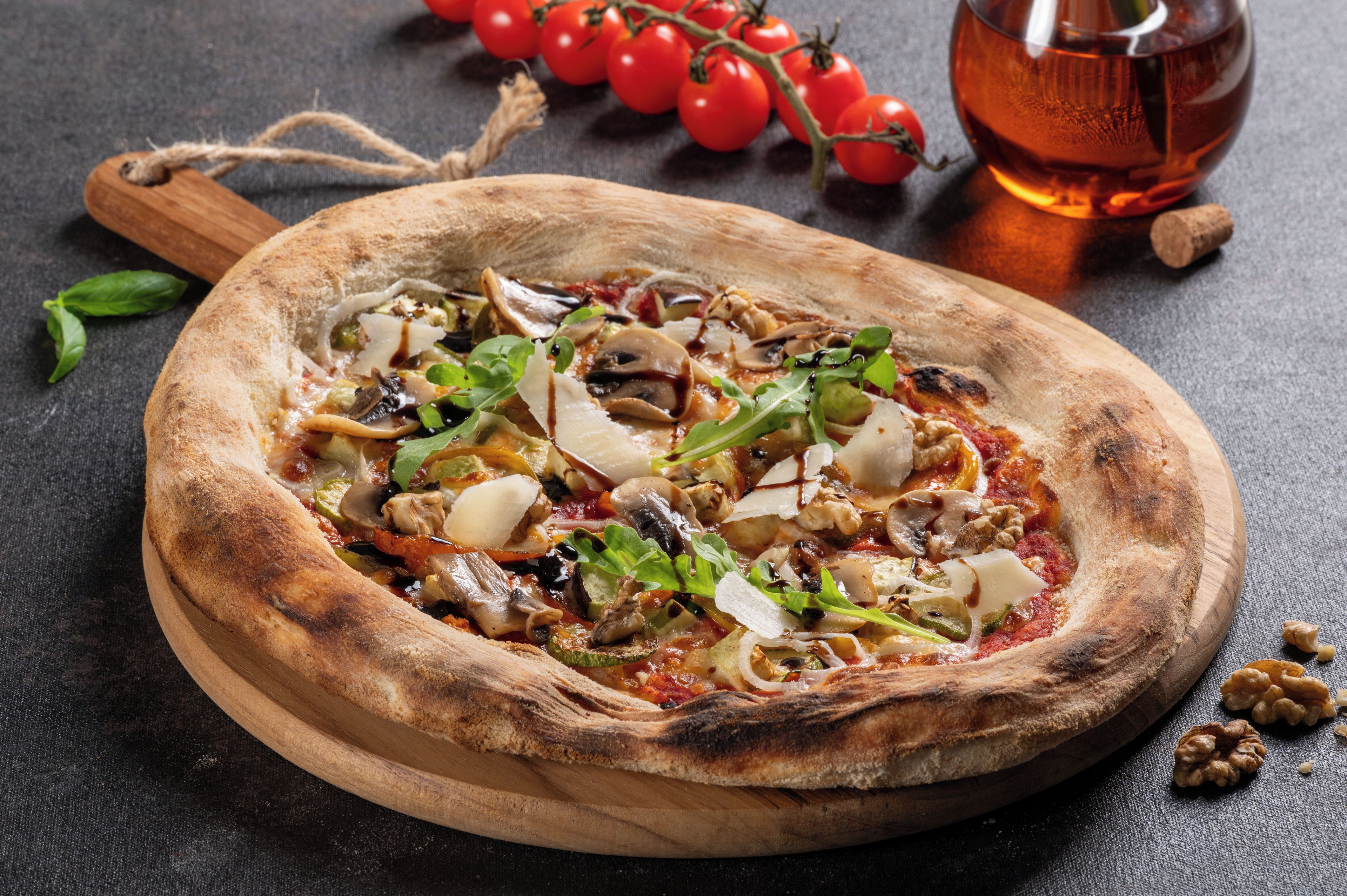 A pizza on a wooden board with a rustic appearance.