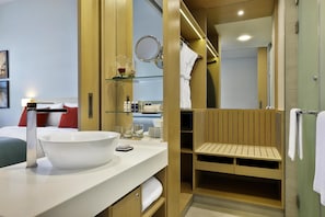 A modern bathroom with a large white sink, a mirror, and a wooden vanity. - Avani Ibn Battuta Dubai Hotel (Dubai)