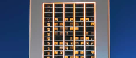 A high-rise building with a prominent sign reading 'AVANI' at the top.