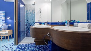 A modern bathroom with two sinks, a large mirror, and a shower area. - Aquae Romanae Piazza Lauro (Sorrento)