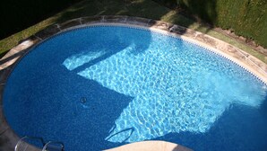 A clear, blue swimming pool with a tiled edge and a ladder. - Oliva: House / Villa - Oliva (Oliva)