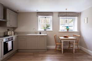 Enjoy cooking in this well-equipped kitchen with a central island, sink, and oven.