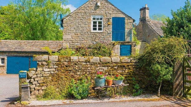 A stone house with a blue door, a small window, and a chimney. - Heathy Lea Barn Chatsworth Estate (Baslow)