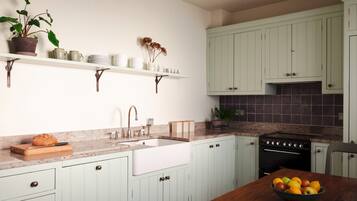 Fridge, dishwasher, coffee/tea maker, cookware/dishes/utensils