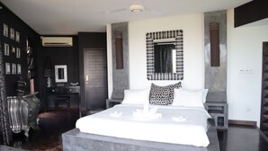 A modern bedroom with a large bed, a dresser, and a vanity. - The Bukit Ocean View Villa Jimbaran (Jimbaran)