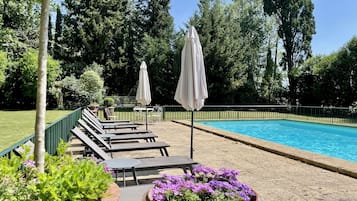 Seasonal outdoor pool, open 9:00 AM to 9:00 PM, pool umbrellas