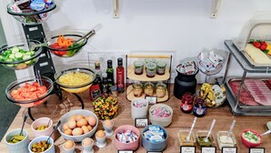 A buffet with various food items and condiments. - Elisabeth Old Town (Bratislava)