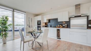 Two-Bedroom Apartment | Private kitchen | Full-sized fridge, microwave, oven, stovetop