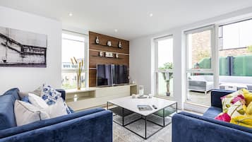 Three-Bedroom Apartment | Living room | 55-inch LED TV with digital channels, TV