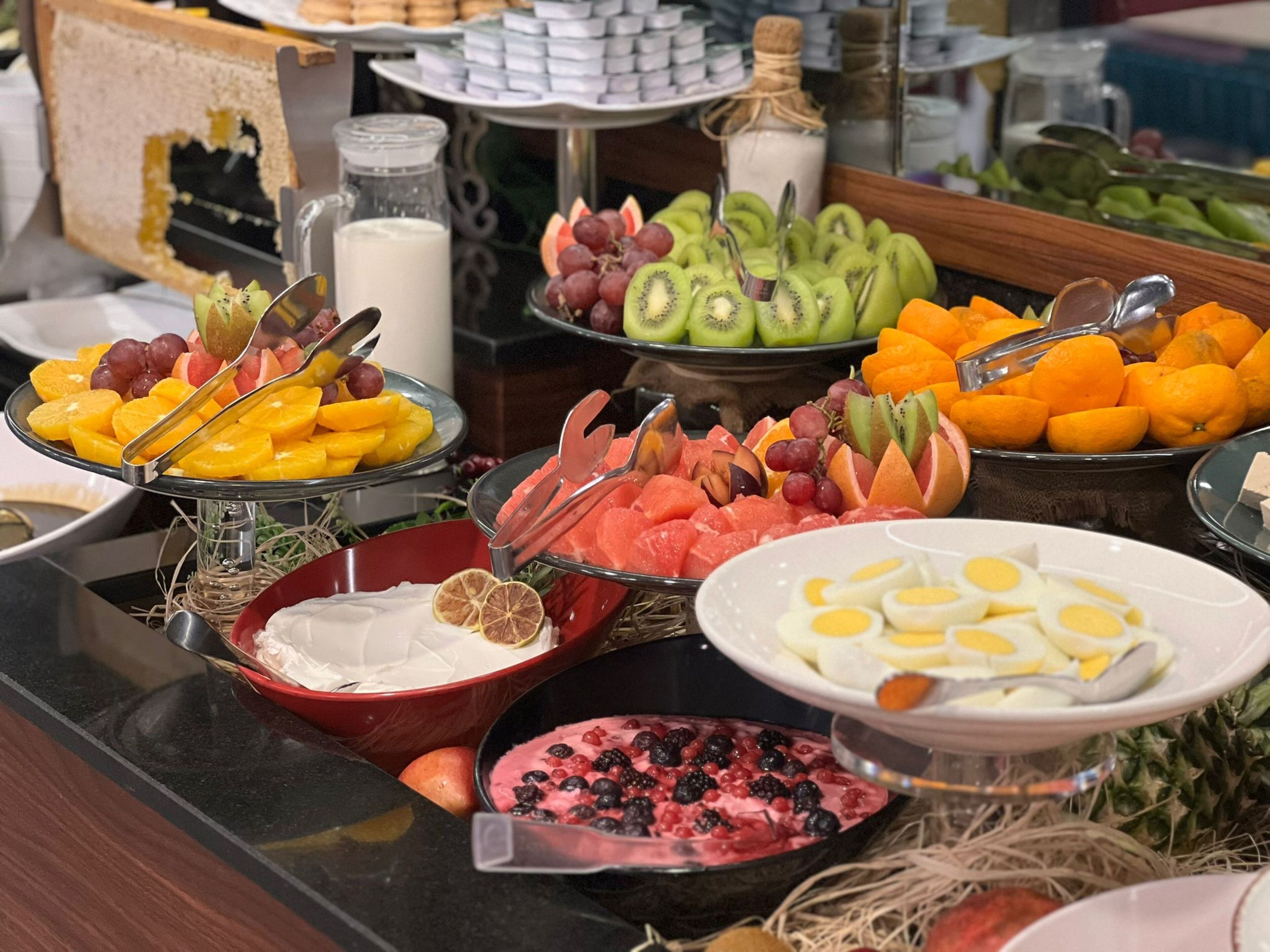 A buffet with various fruits, vegetables, and dairy products.
