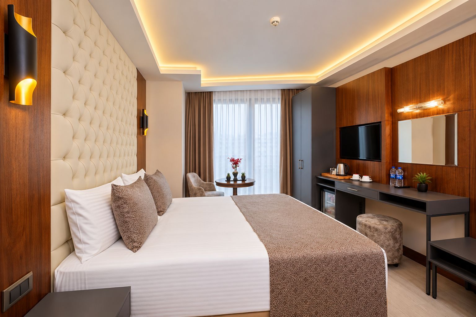 Una habitación de hotel con una cama grande, un escritorio, un televisor y un minibar.