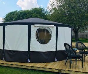 Relax in a spacious, circular retreat with a central window and comfortable seating area.