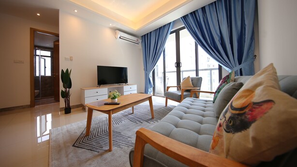 A modern living room with a sofa, a coffee table, and a TV. - R&F Princess Cove at R&F Mall (Johor Bahru)