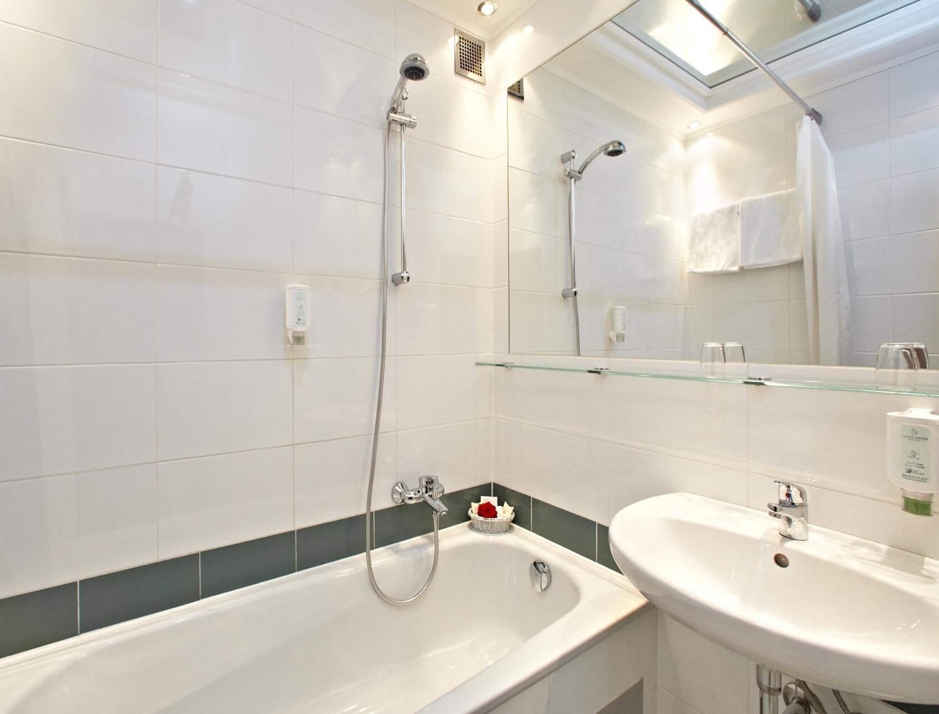 bathtub, deep-soaking bathtub, hair dryer, towels