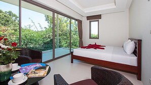 A bedroom with a large window, a bed, a table with a vase of flowers, and a chair. - 2 Bedroom Pool Villa in Quiet Location SDV005 By Samui Dream Villas (Tambon Mae Nam)