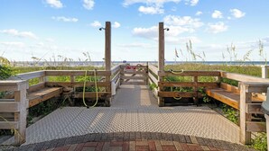 A wooden boardwalk leading to a beach with a sign indicating a no swimming area. - White Caps 1406 | Beachfront Orange Beach Condo | Wrap Balcony, Sleeps 10 (Orange Beach)