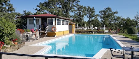 Seasonal outdoor pool, open 9:30 AM to 7:00 PM, pool umbrellas