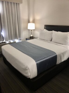 Hypo-allergenic bedding, desk, laptop workspace, blackout curtains