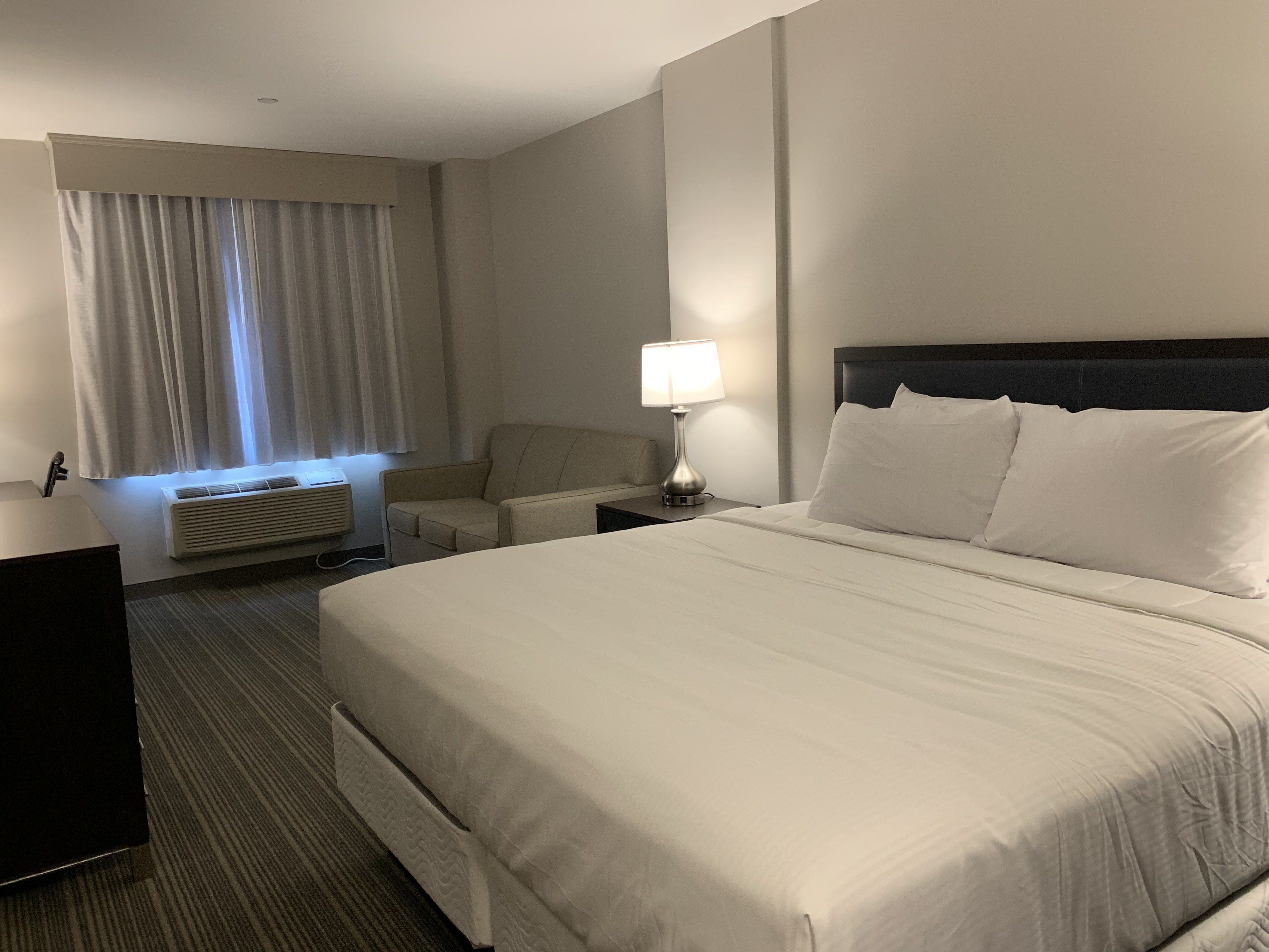 hypo-allergenic bedding, desk, laptop workspace, blackout curtains