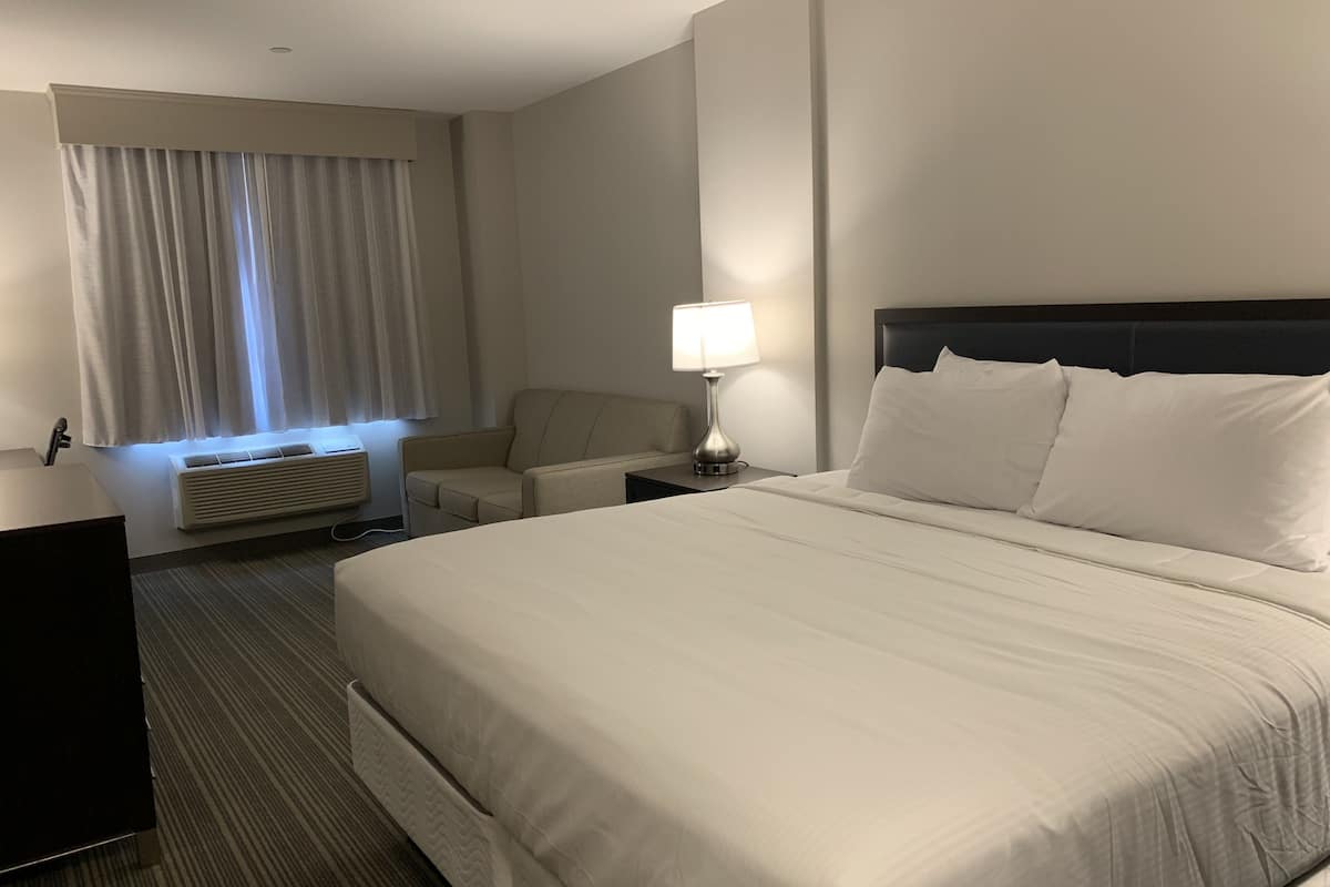 hypo-allergenic bedding, desk, laptop workspace, blackout curtains