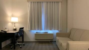 Hypo-allergenic bedding, desk, laptop workspace, blackout drapes