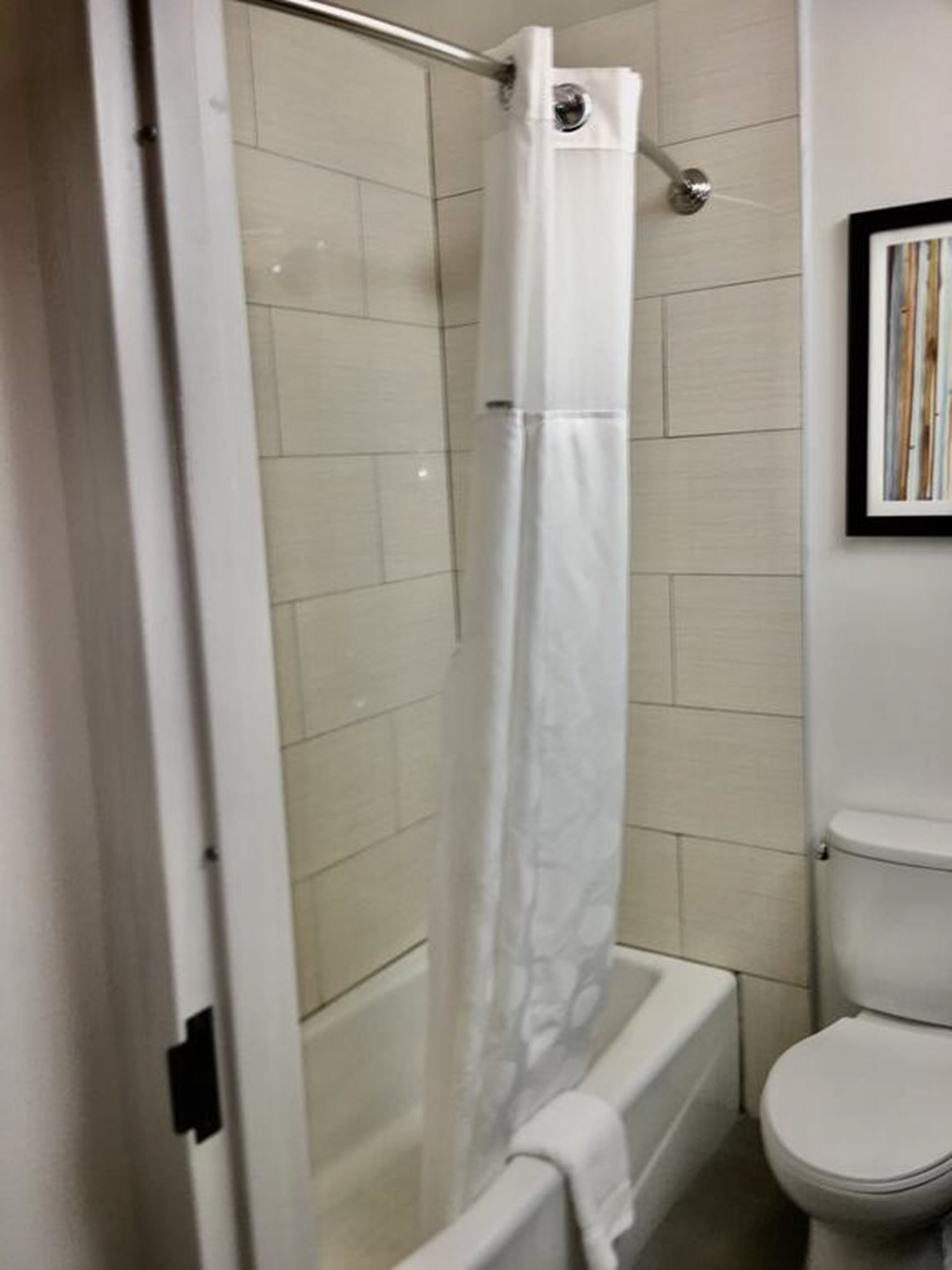 combined shower/bathtub, hair dryer, towels, soap
