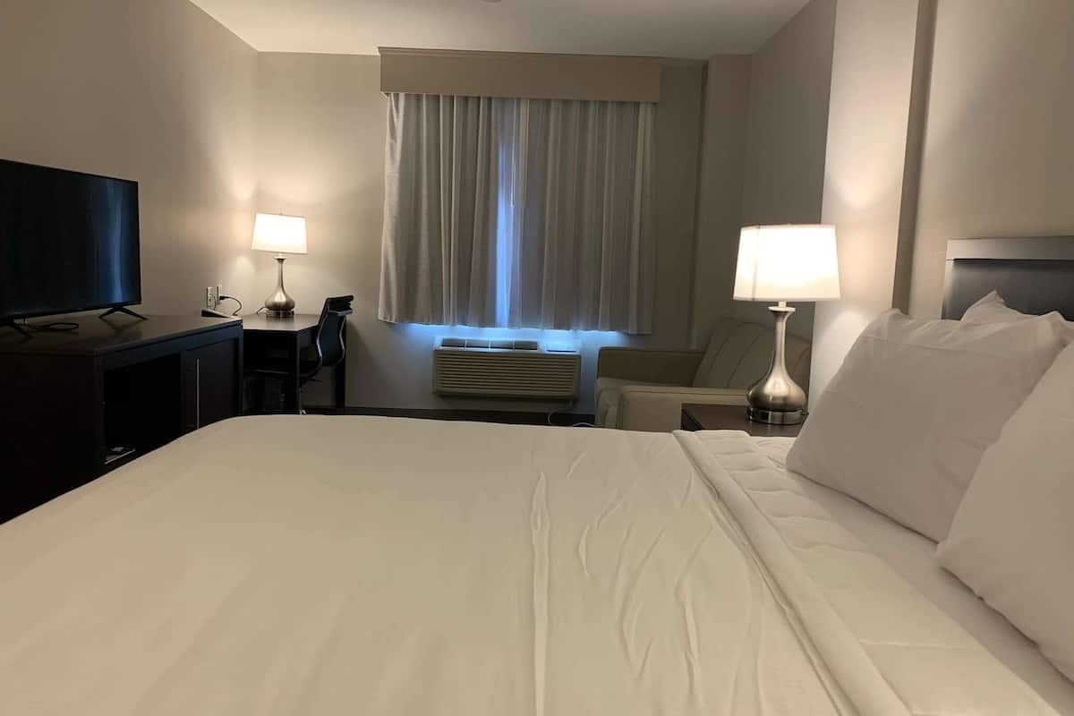 hypo-allergenic bedding, desk, laptop workspace, blackout curtains